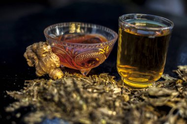 Remedy for asthma on the wooden surface consisting of some ardusi leaves, honey, ginger and leaf juice well mixed for the treatment. Horizontal shot with the spotlight.