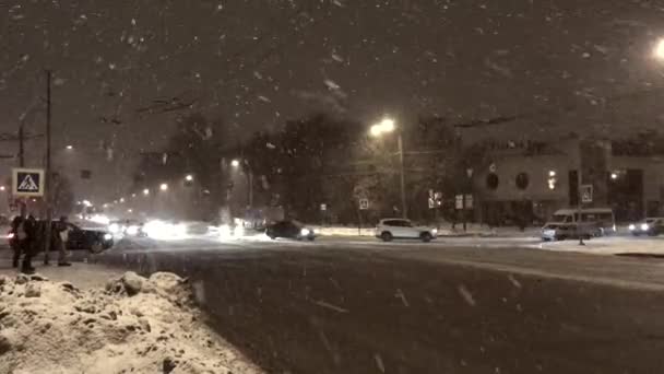 Många stora snöflingor falla på vägen går bilen. Ryssland, Sankt-Petersburg, 18 November 2016 — Stockvideo