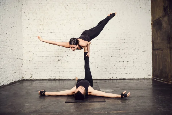 Young athletic couple practicing acroyoga