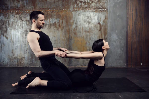 Athletic couple practicing acroyoga