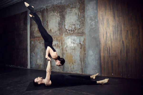 Athletic couple practicing acroyoga