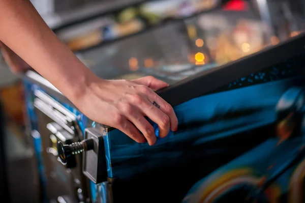 Close up shot of person playing with a pinball machine — Stock Photo, Image
