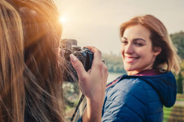 Shot of a girl photographer taking a photo of a her friend — Stock Photo, Image