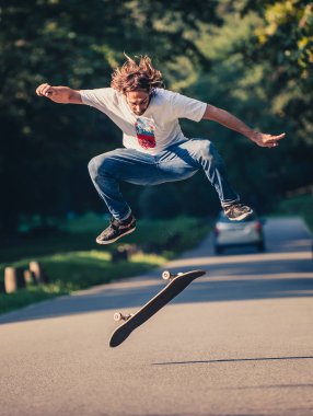 Action shot of a skateboarder skating, doing tricks and jumping clipart