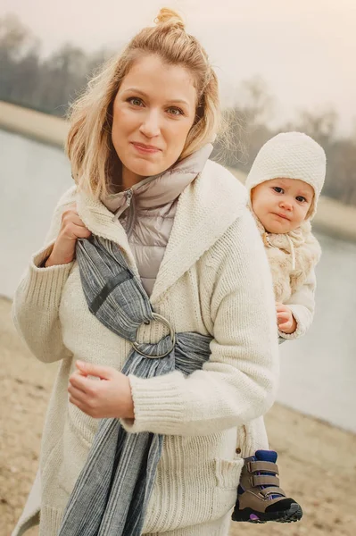 Genç anne bebek taşıyıcı eşarp küçük kızı olan — Stok fotoğraf