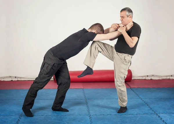 Street fighting self defense technique against holds and grabs