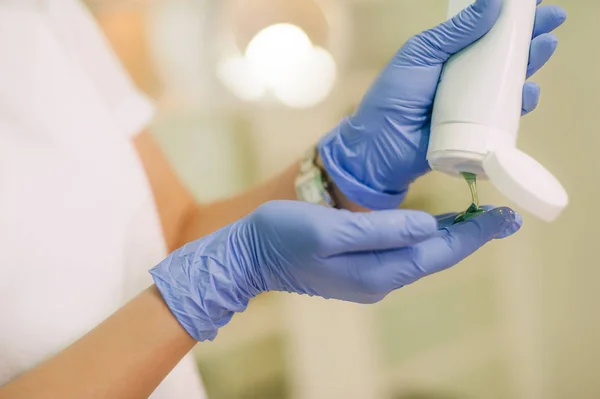 Beautician applying chemical peels on hands for peeling treatmen