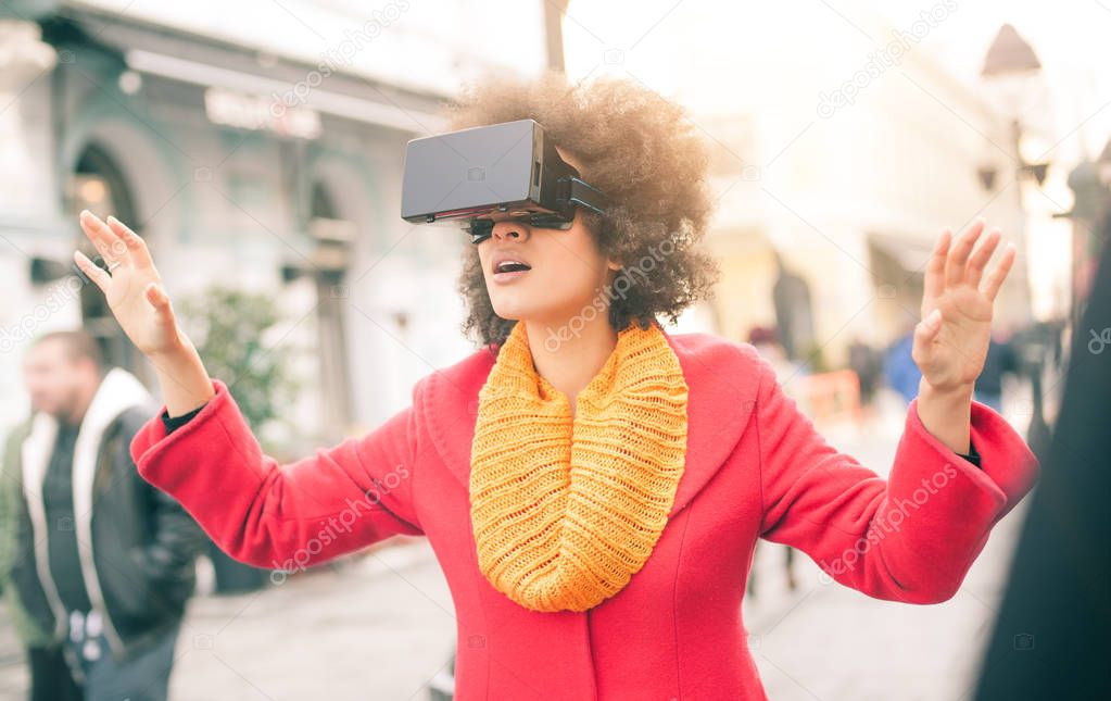 Beautiful woman using high tech virtual reality glasses outdoor