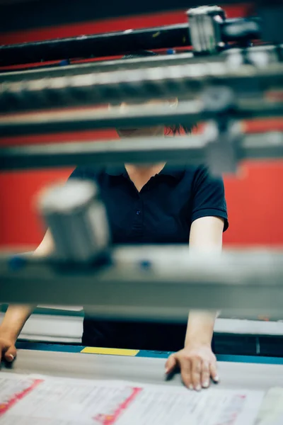 Mujer joven trabajando en la fábrica de impresión — Foto de Stock