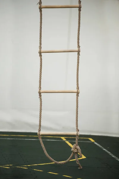 Stairs of rope for climbing in sport school gym hall — Stock Photo, Image