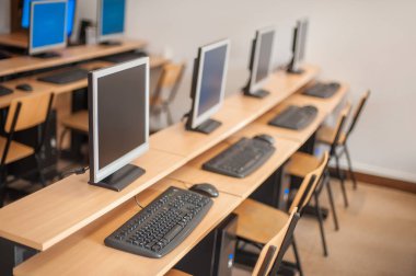 Photo of row computers in classroom or other educational institu clipart