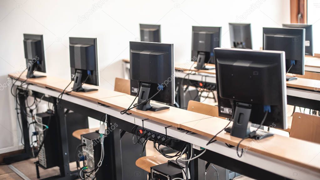 Photo of row computers in classroom or other educational institu