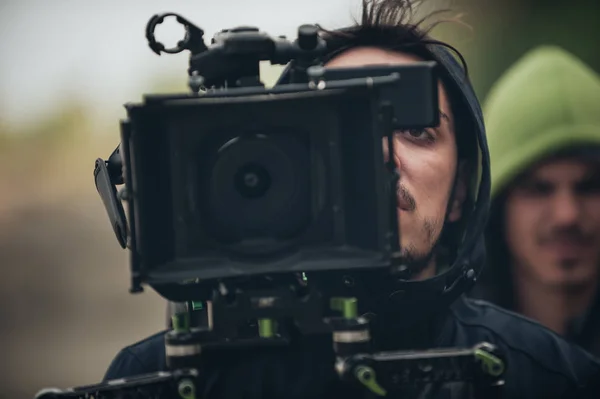 Behind the scene. Cameraman shooting film scene with his camera — Stock Photo, Image