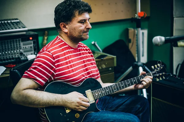 Por trás da cena. Prática de guitarrista tocando guitarra na música desarrumado s — Fotografia de Stock