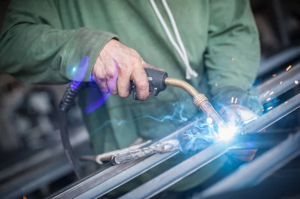 Industrial worker welding the steel structure in the workshop — Stock Photo, Image