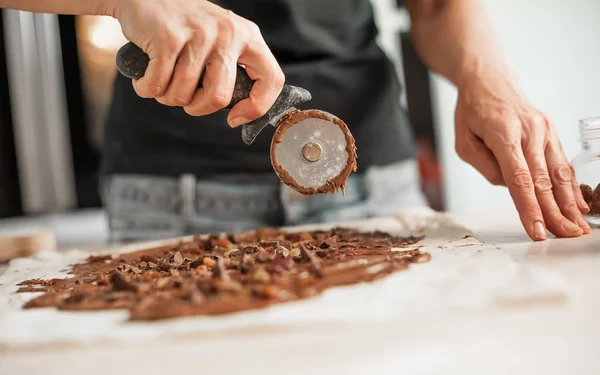 Professional confectioner making tasty cake with melted chocolat