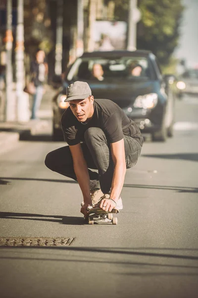Pro skateboarder ride skateboard on capital road street through — Stock Photo, Image