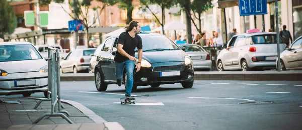 Pattinatore professionista pattinaggio a cavallo sulle strade attraverso auto e tra — Foto Stock