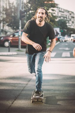 Şehir yolda araba önünde Pro kaykay binici