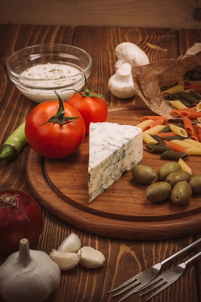 Food ingredients for preparing pasta on rustic kitchen table — Stock Photo, Image