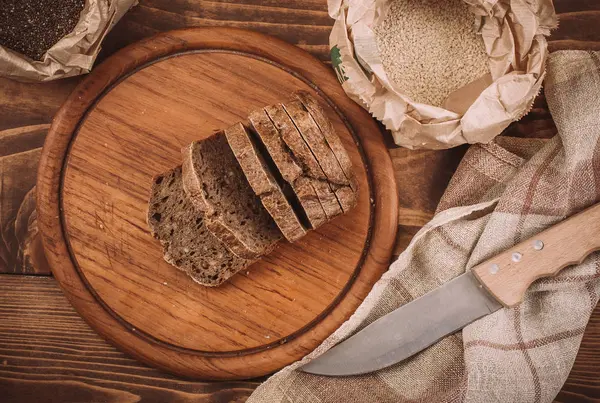Muchos panes y panecillos horneados mixtos en mesa de madera rústica — Foto de Stock