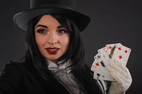 Female magician in performer suit with magic wand and playing ca — Stock Photo, Image