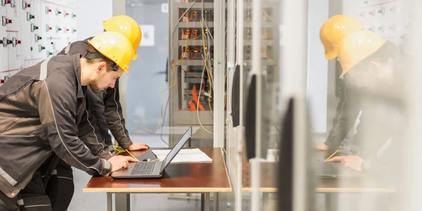 Two Maintenance Engineers Inspect Relay Protection System Laptop Computer Bay — Stock Photo, Image