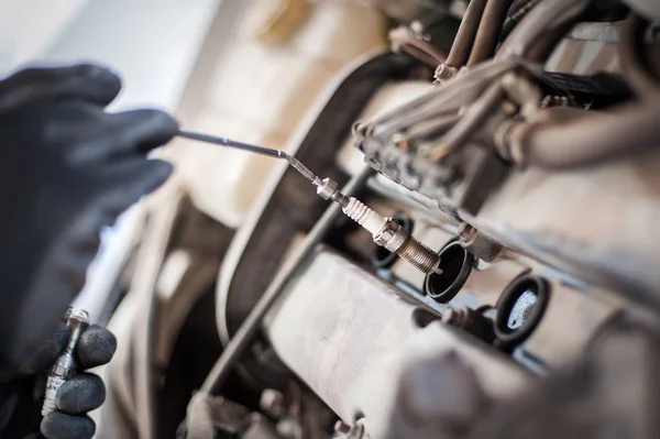 Otomatik tamirci arabanın bujilerini değiştiriyor — Stok fotoğraf