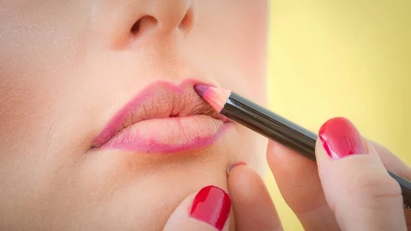 Maquillaje artista profesional aplicando lápiz labial en los labios con lápiz — Foto de Stock