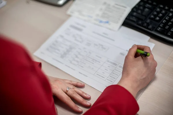 Close-up of female accountant hands, calculates and research the financial data position of the company and planning the economy financial profit or loss of bank accounts
