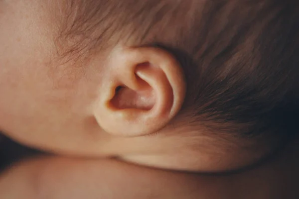 Newborn baby's ear close upconcept of childhood, health care, IVF, hygiene — Stock Photo, Image