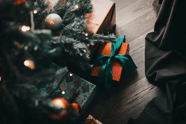 Ağacın altında, masanın üstünde, bulanık ışıkların arka planında, bokeh. Noel ve Yeni Yıl kavramı. — Stok fotoğraf