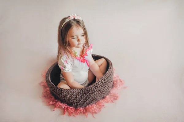 Girl sitting in a basket. concept of childhood, health care, IVF — Stock Photo, Image