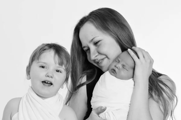 concept of healthy lifestyle, the protection of children, shopping - baby in the arms of the mother. Woman holding a child. Tree girls. Isolated on white background. Copy space. 8 march, mother\'s day