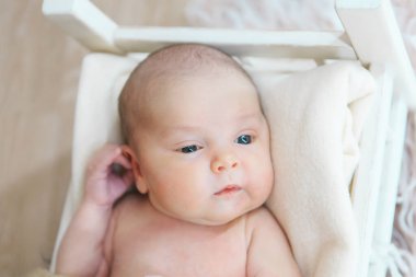 portrait of a little girl: baby's face with hand near the face close-up. concept of childhood, healthcare, IVF