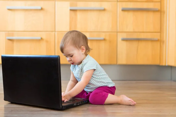 small child plays on computer. The child Prodigy learns the techniques of business Planning, home work, quarantine, self-isolation, protection from coronavirus, virus, home education, distance work.