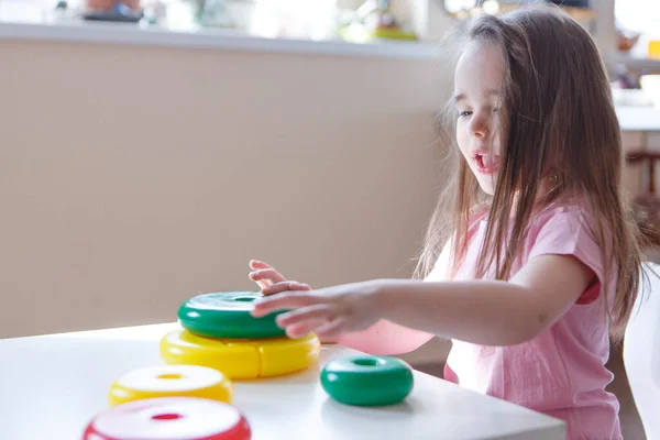 the child collects a pyramid. Details of the toy in the hands. Concept of development of fine motor skills, educational games, childhood, IVF, children\'s day, kindergarten copy space