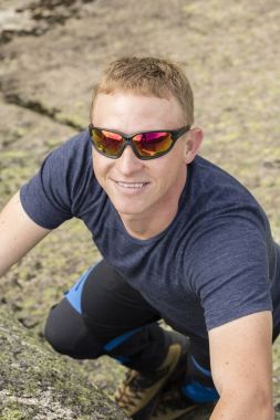 Bir dağcı tırmanma çalışmaları büyük bir kaya üzerinde yapar.