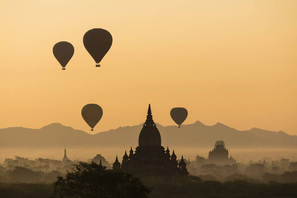 BAGAN, MYANMAR, JANUARY 2, 2018: Balloon silhouette with sunrise