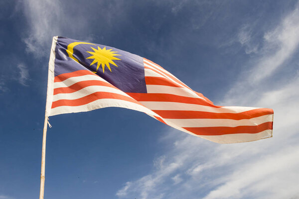 Malaysia flag also known as Jalur Gemilang wave with the blue sky