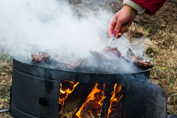 Grilling meat on wood stove — Stock Photo, Image