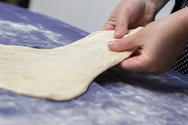 Creating homemade Phyllo or strudel dough on a home table cloth — Stock Photo, Image