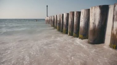 Dalgalar, beyaz kum. Deniz, okyanus, su, dalgalar yıkama ahşap bir iskele