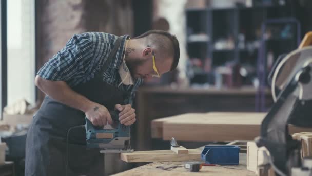 Стильный ремесленник на рабочем месте. Современный деревообработчик с татуировкой . — стоковое видео