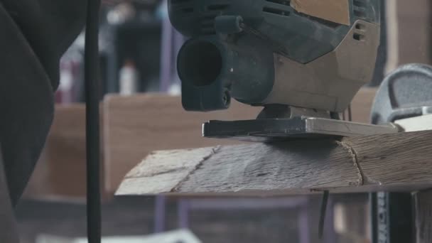 Close-up of a piece of wood cut electric jigsaw. Slow motion — Stock Video