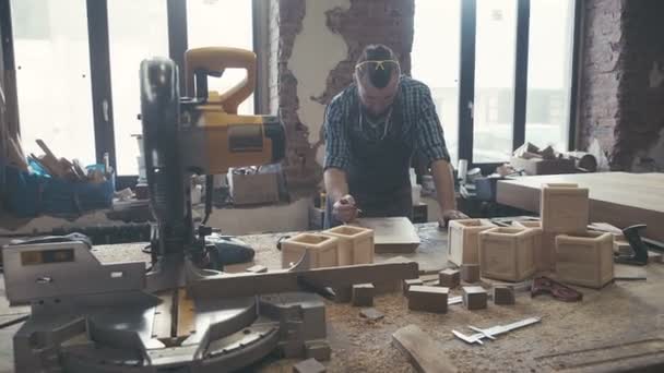 Workplace of cabinetmaker. Carpenter works with a planer in a workshop — Stock Video