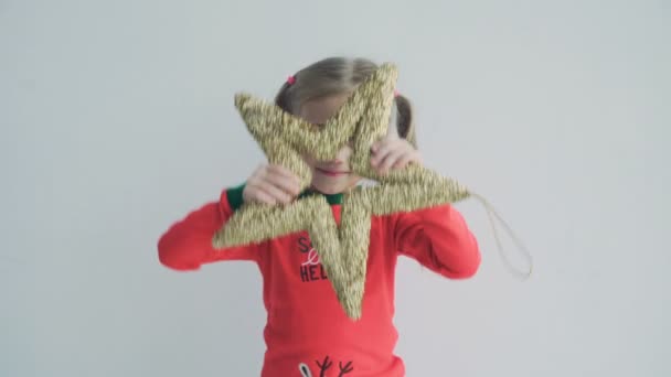 Portrait of a cute little girl with two pigtails in red pajamas — Stock Video