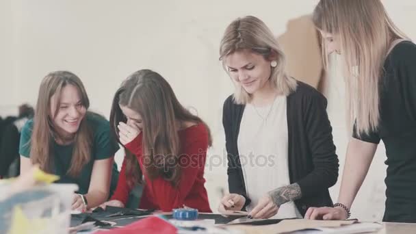 Frauengruppe in einer Nähwerkstatt: Auf dem Tisch Stoffe, Nähwerkzeug — Stockvideo