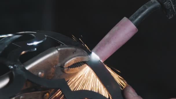 Metal sparks fly apart from the detail. Decorative metal products. — Stock Video