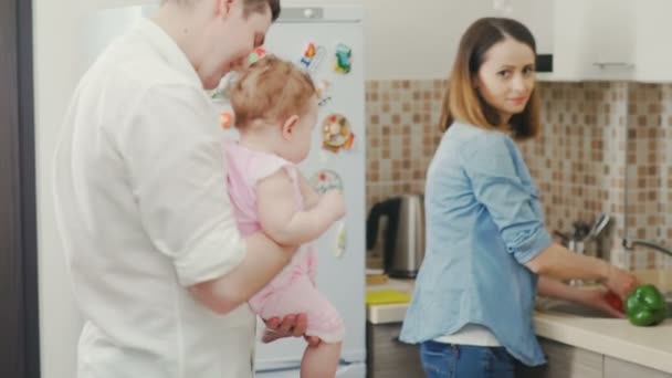 Beautiful woman prepares breakfast for her family in a cozy kitchen — Stock Video